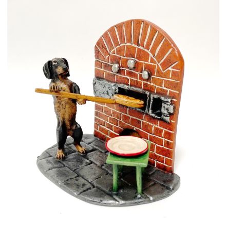 Dackel Pizzabäcker bei Ofen